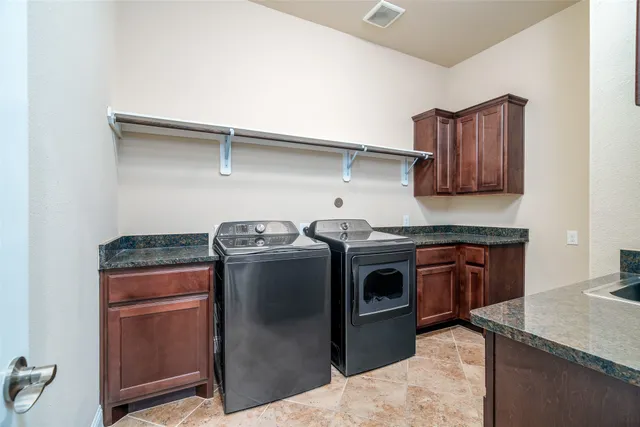 a kitchen with stainless steel appliances granite countertop a stove and a refrigerator
