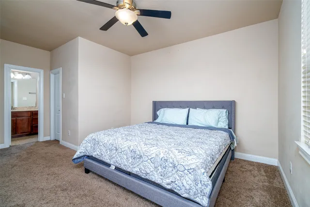 a bedroom with a bed and ceiling fan