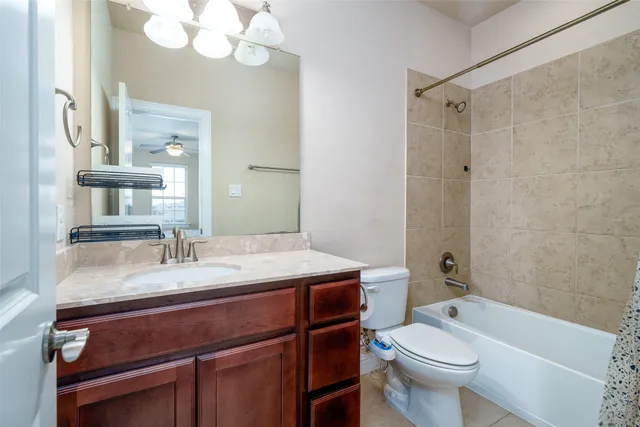 a bathroom with a sink vanity mirror and toilet