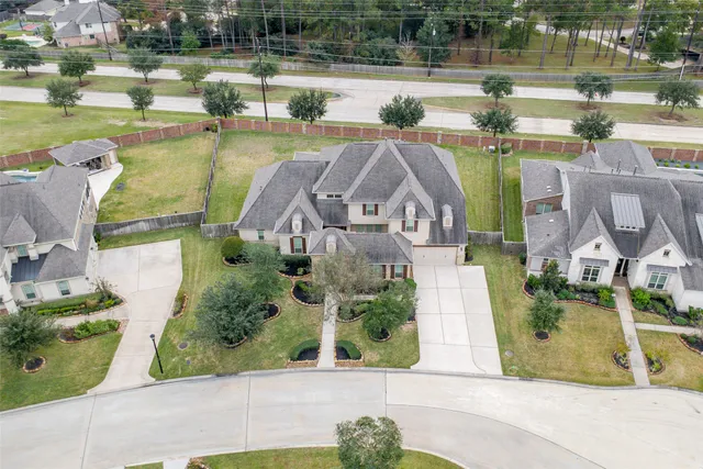an aerial view of a house with a lake view