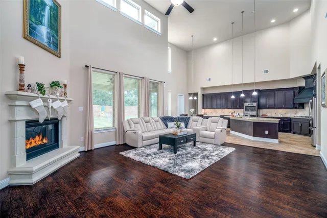 a living room with fireplace furniture and a wooden floor