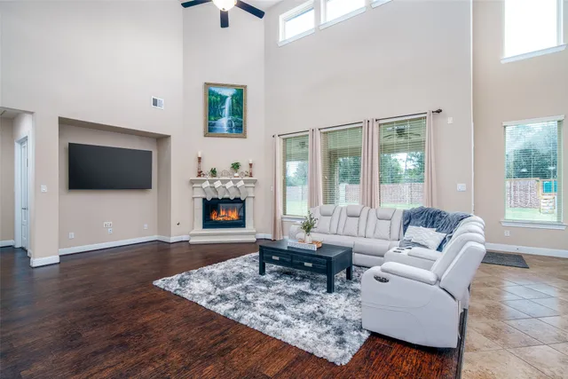 a living room with furniture a flat screen tv and a fireplace