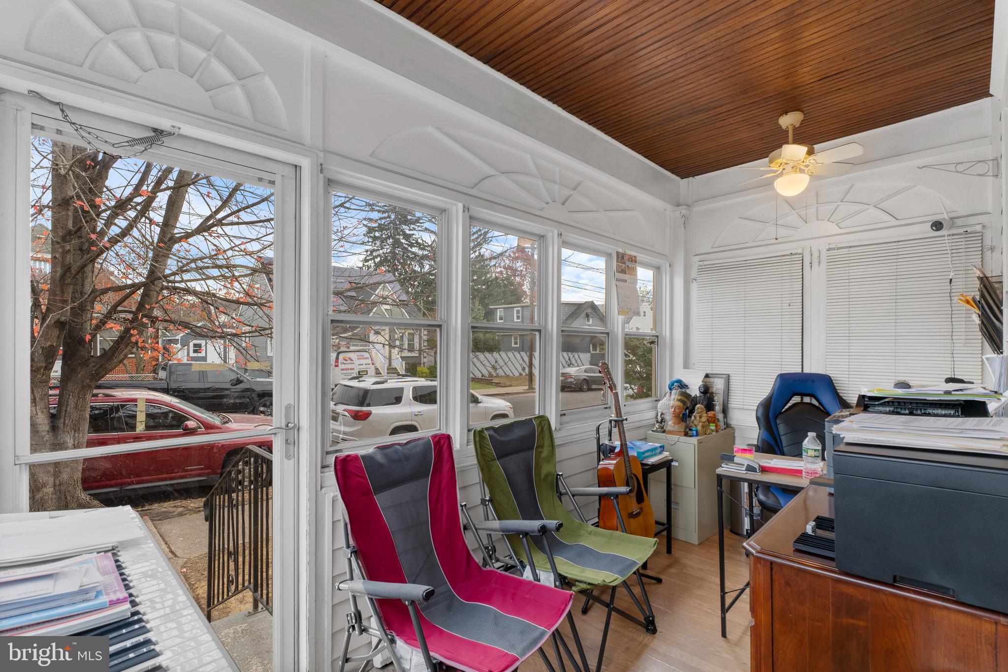 69 Reed Avenue Hamilton, NJ 08610 - Photo 11 of 17 a living room with furniture a rug and a floor to ceiling window