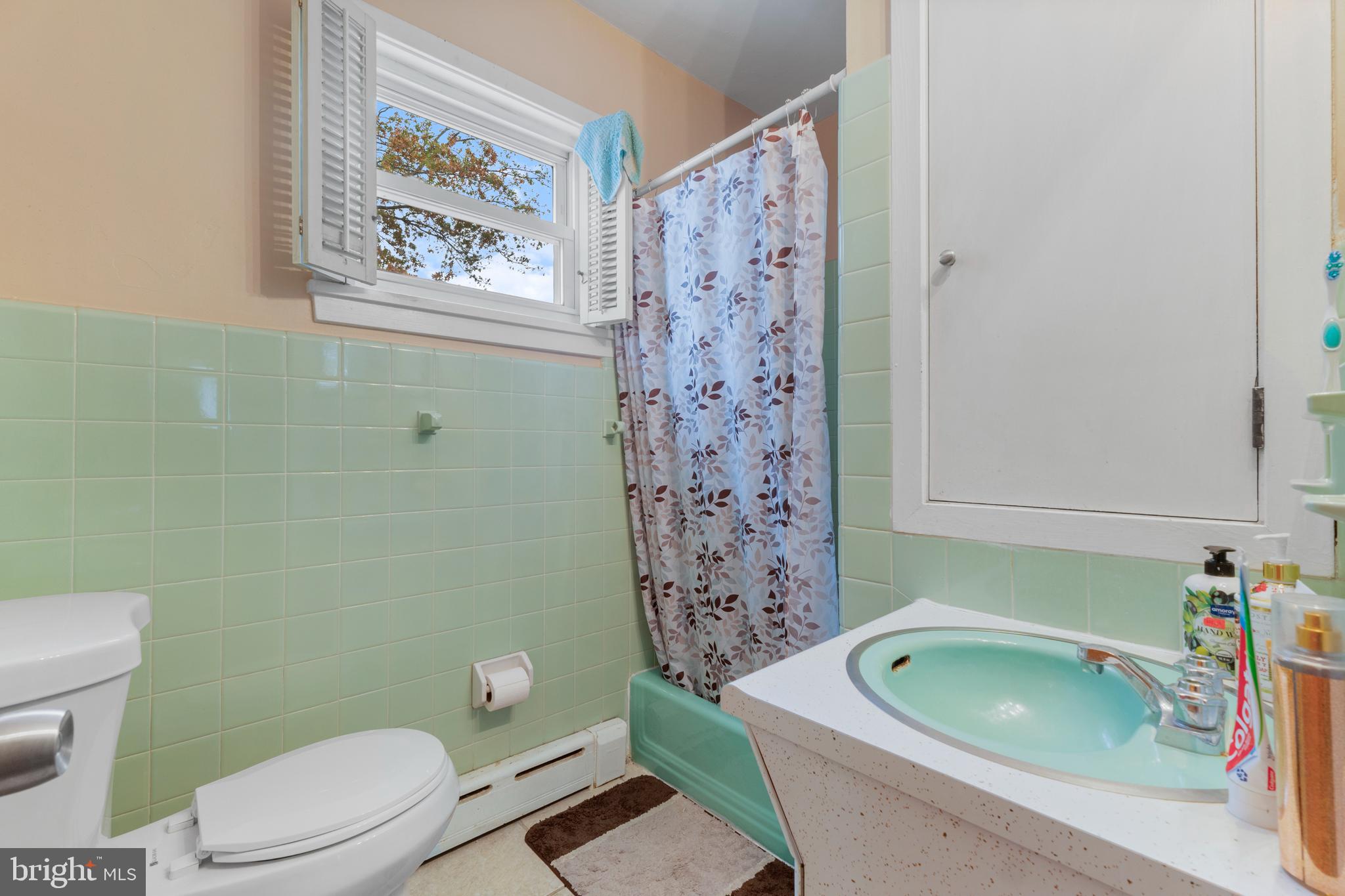 69 Reed Avenue Hamilton, NJ 08610 - Photo 12 of 17 a bathroom with a toilet a sink and bathtub