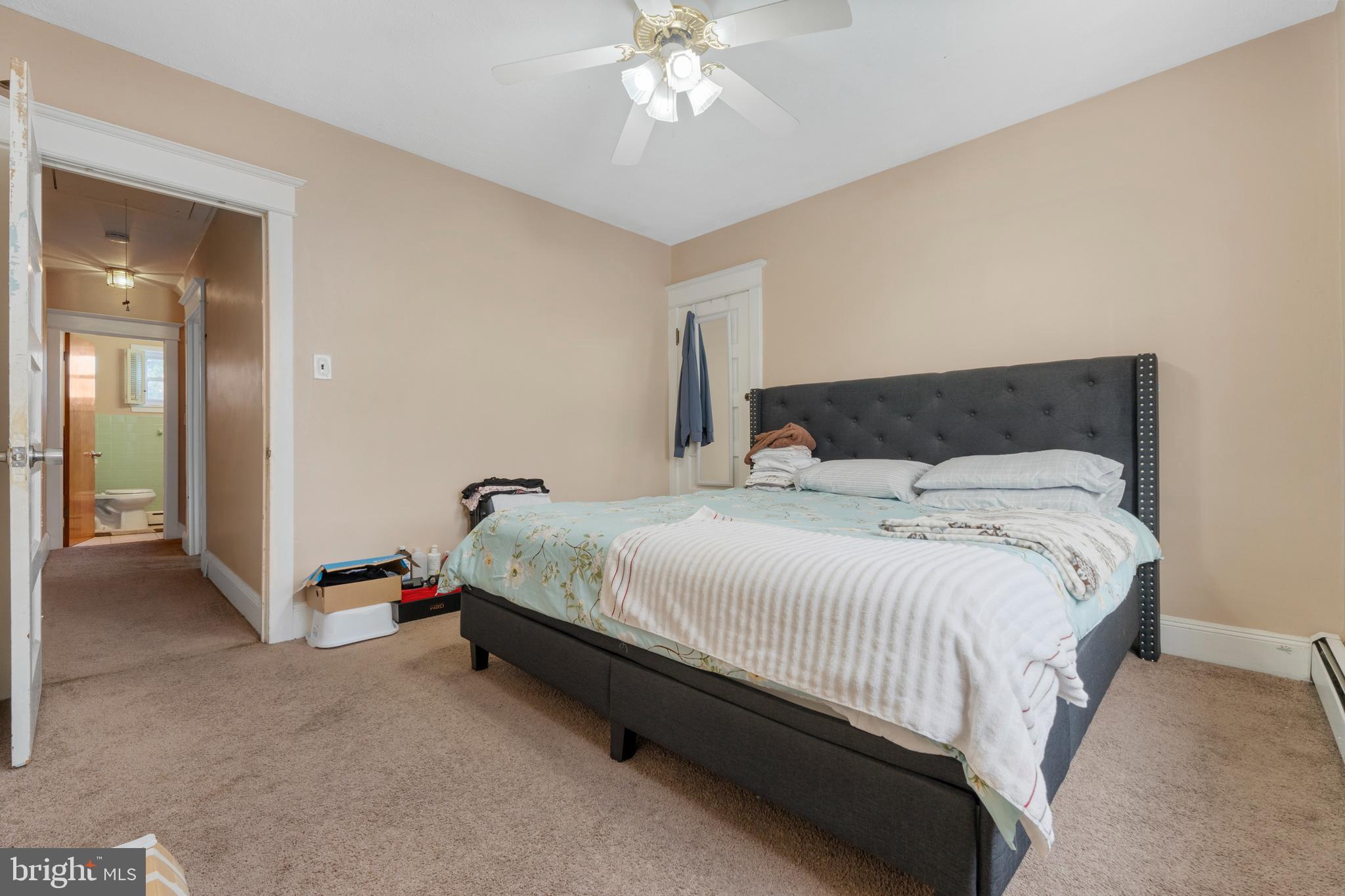 69 Reed Avenue Hamilton, NJ 08610 - Photo 16 of 17 a bedroom with a bed and a chandelier
