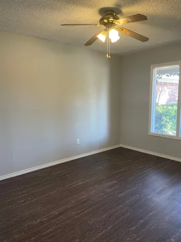 an empty room with wooden floor and closet