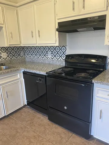 a close view of a stove a microwave and cabinets