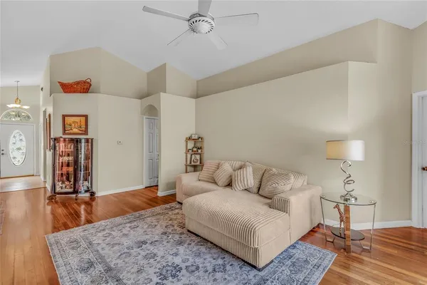 a living room with furniture and wooden floor