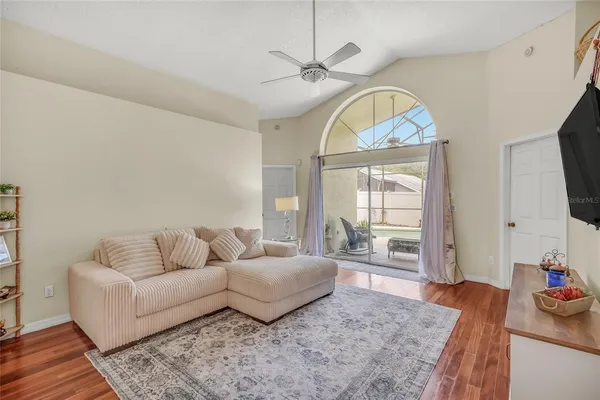 a living room with furniture a fireplace and a flat screen tv