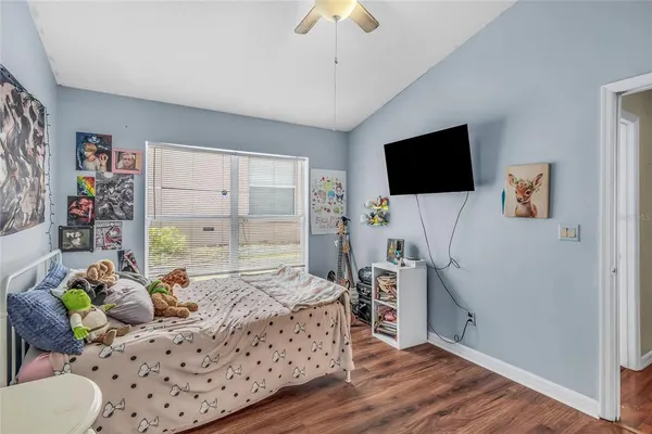a bedroom with furniture and a flat screen tv