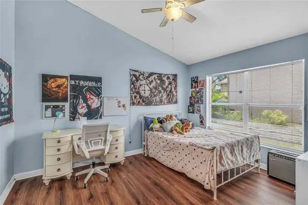 a bedroom with furniture and a wooden floor