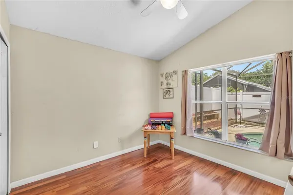 a living room with a wooden floor and a table
