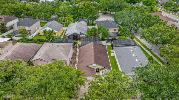 an aerial view of a house with garden space and a street view