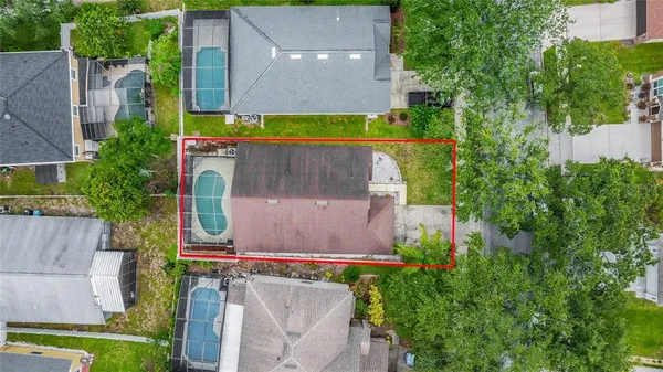 an aerial view of a house with a yard