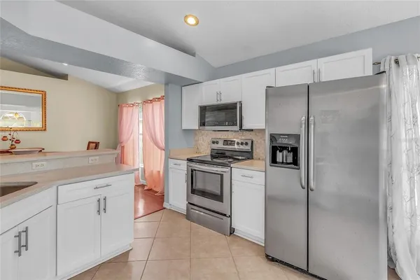 a kitchen with cabinets stainless steel appliances and a counter space