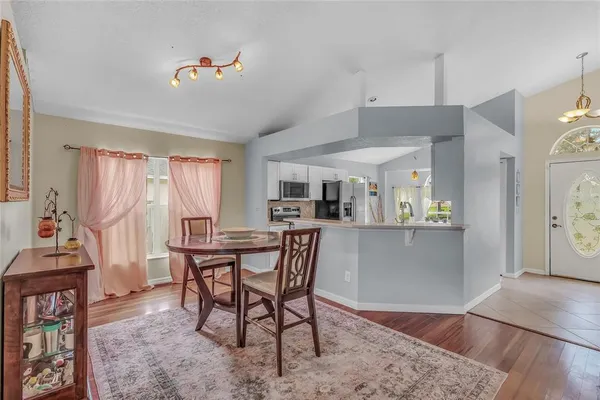 a view of a dining room with furniture window and wooden floor