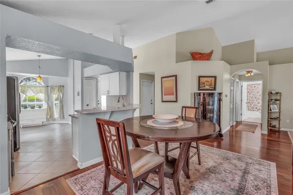 a dining room with furniture and wooden floor