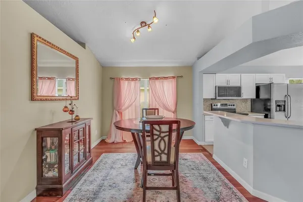 a view of a dining room with furniture window and wooden floor