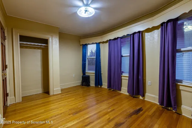 a view of a room with wooden floor and walls