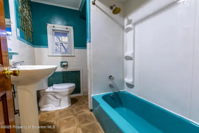 a bathroom with a sink toilet and bathtub