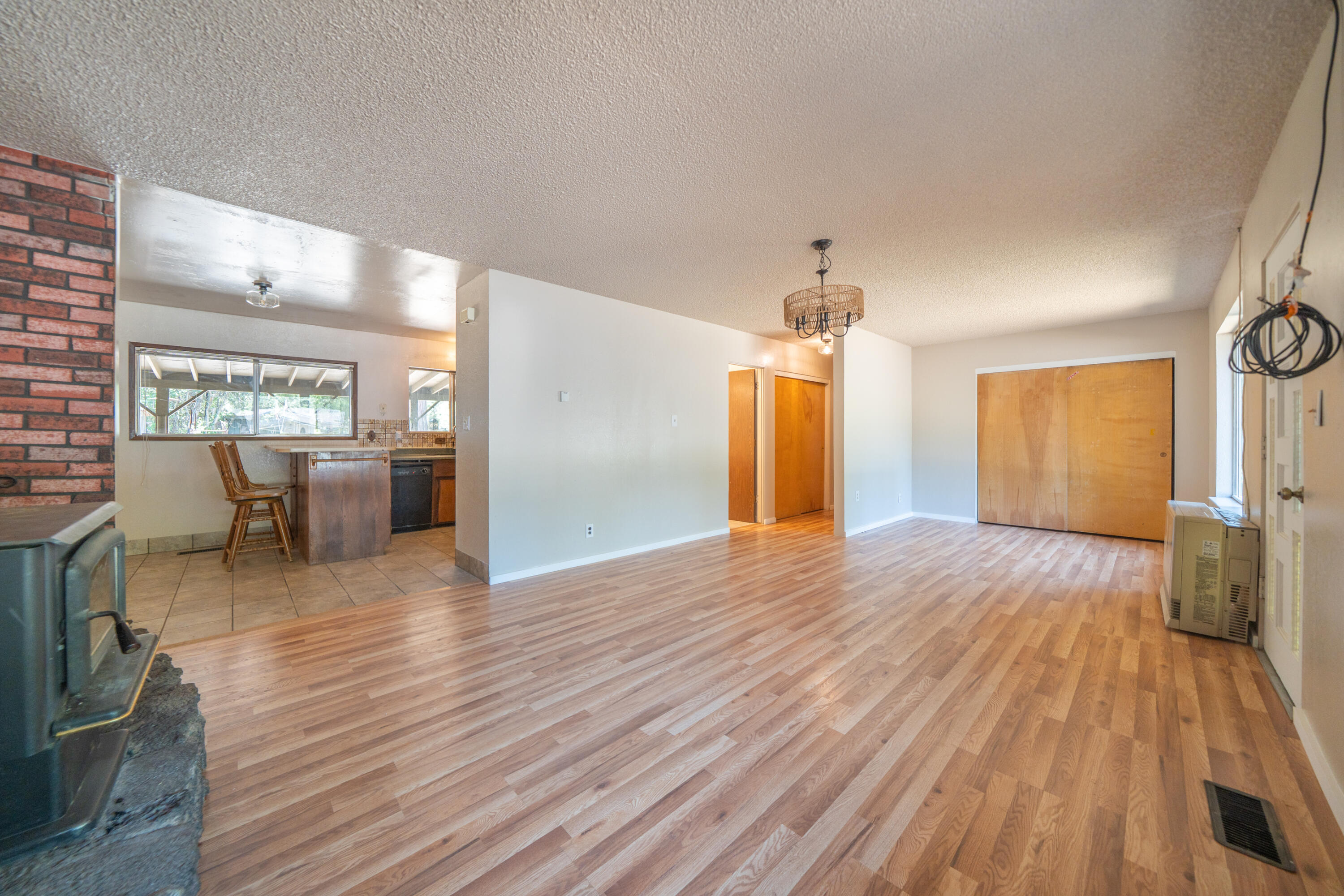37347 Cypress Avenue Burney, CA 96013 - Photo 11 of 62 a view of a livingroom with furniture hardwood floor and a kitchen