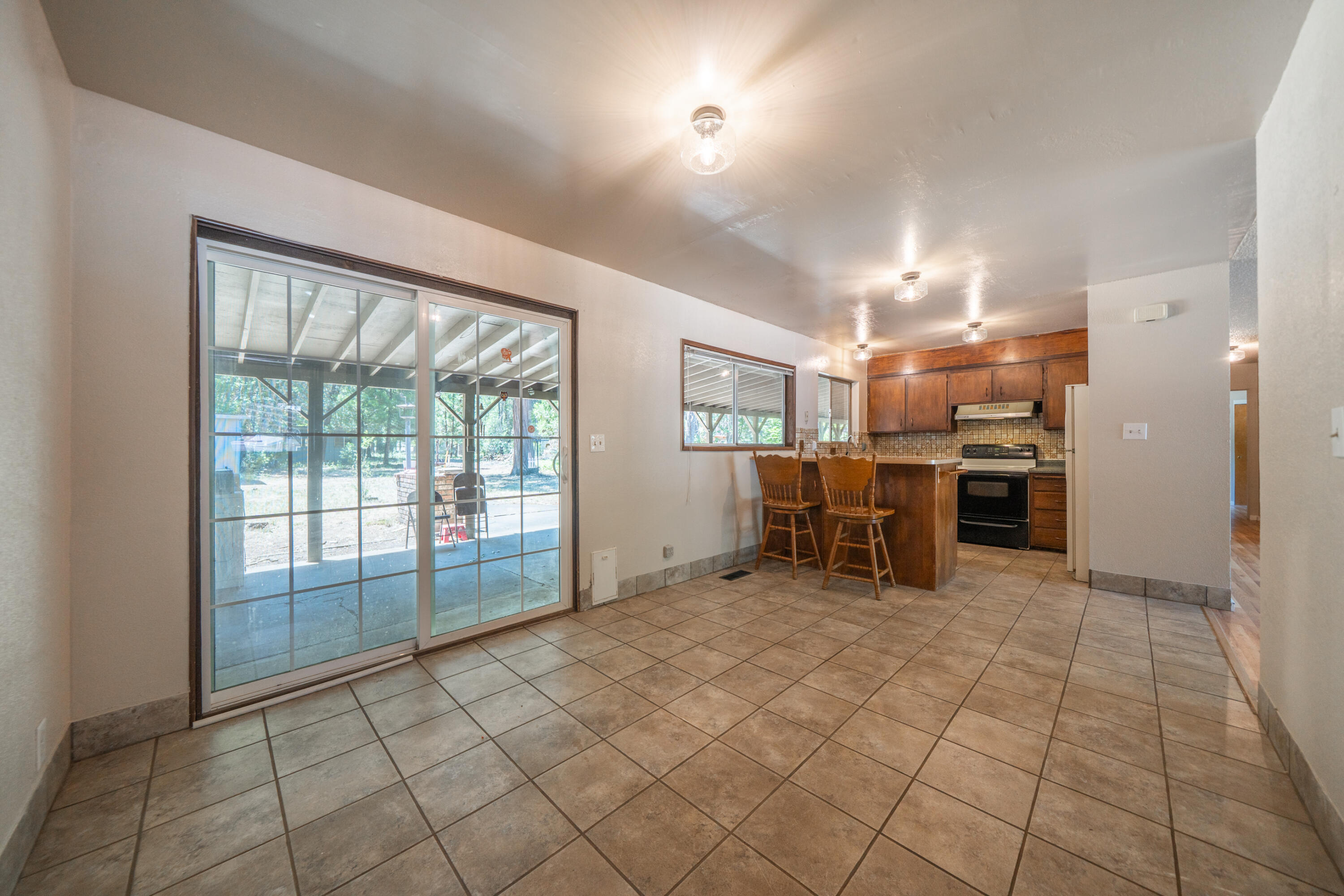 37347 Cypress Avenue Burney, CA 96013 - Photo 15 of 62 a view of a kitchen with furniture and a refrigerator