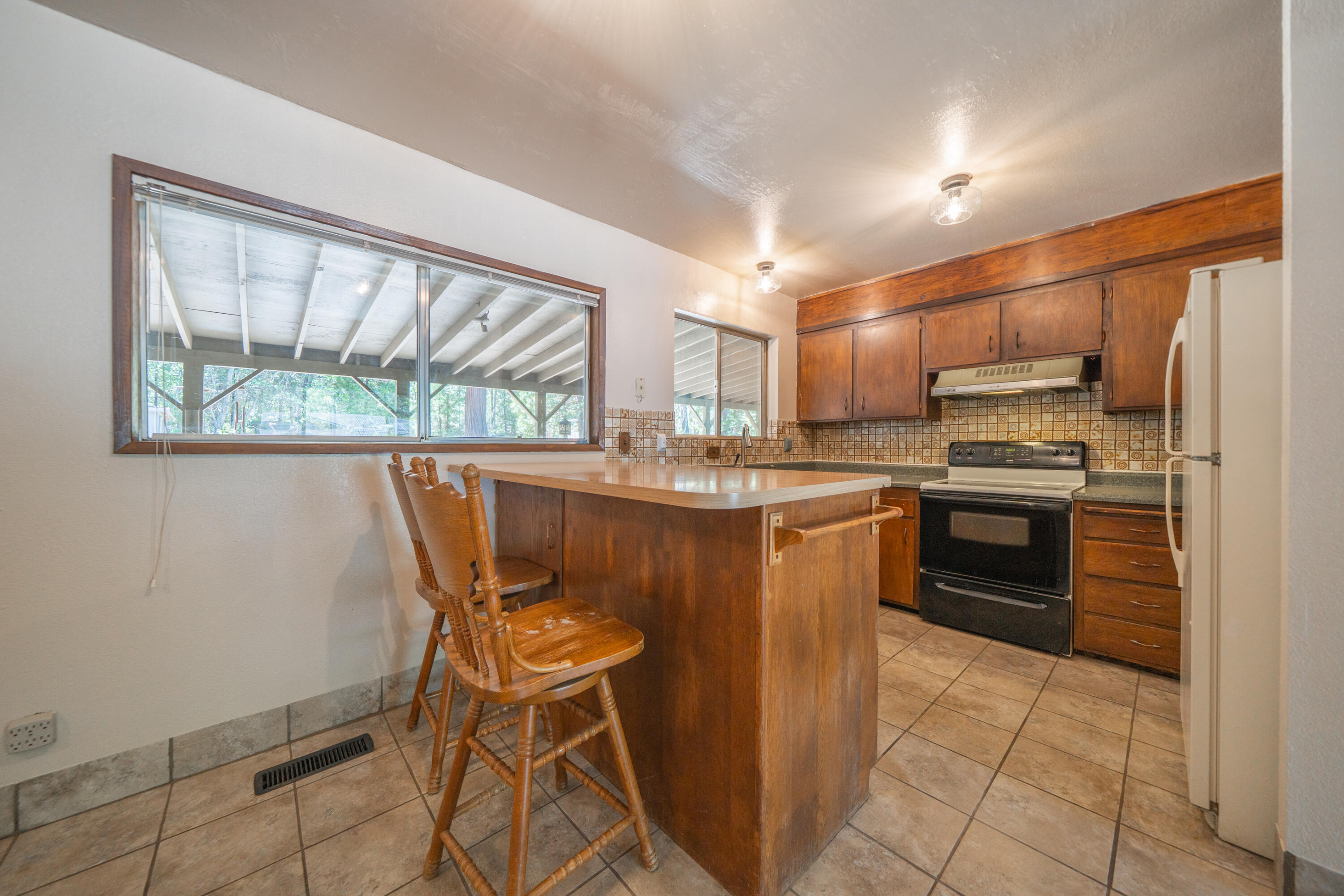 37347 Cypress Avenue Burney, CA 96013 - Photo 16 of 62 a kitchen with stainless steel appliances granite countertop a stove a sink and a refrigerator
