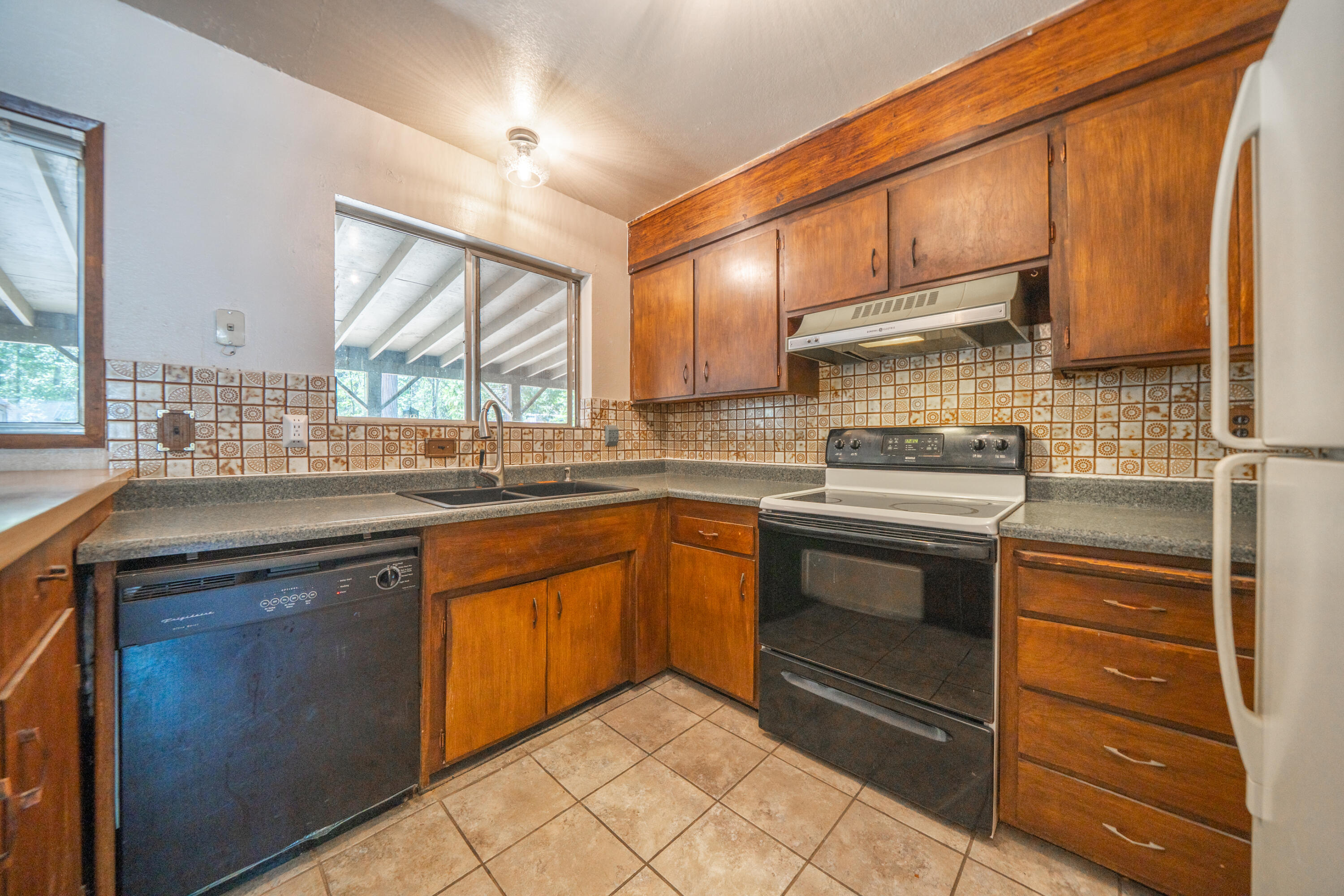 37347 Cypress Avenue Burney, CA 96013 - Photo 17 of 62 a kitchen with stainless steel appliances granite countertop a sink stove and cabinets