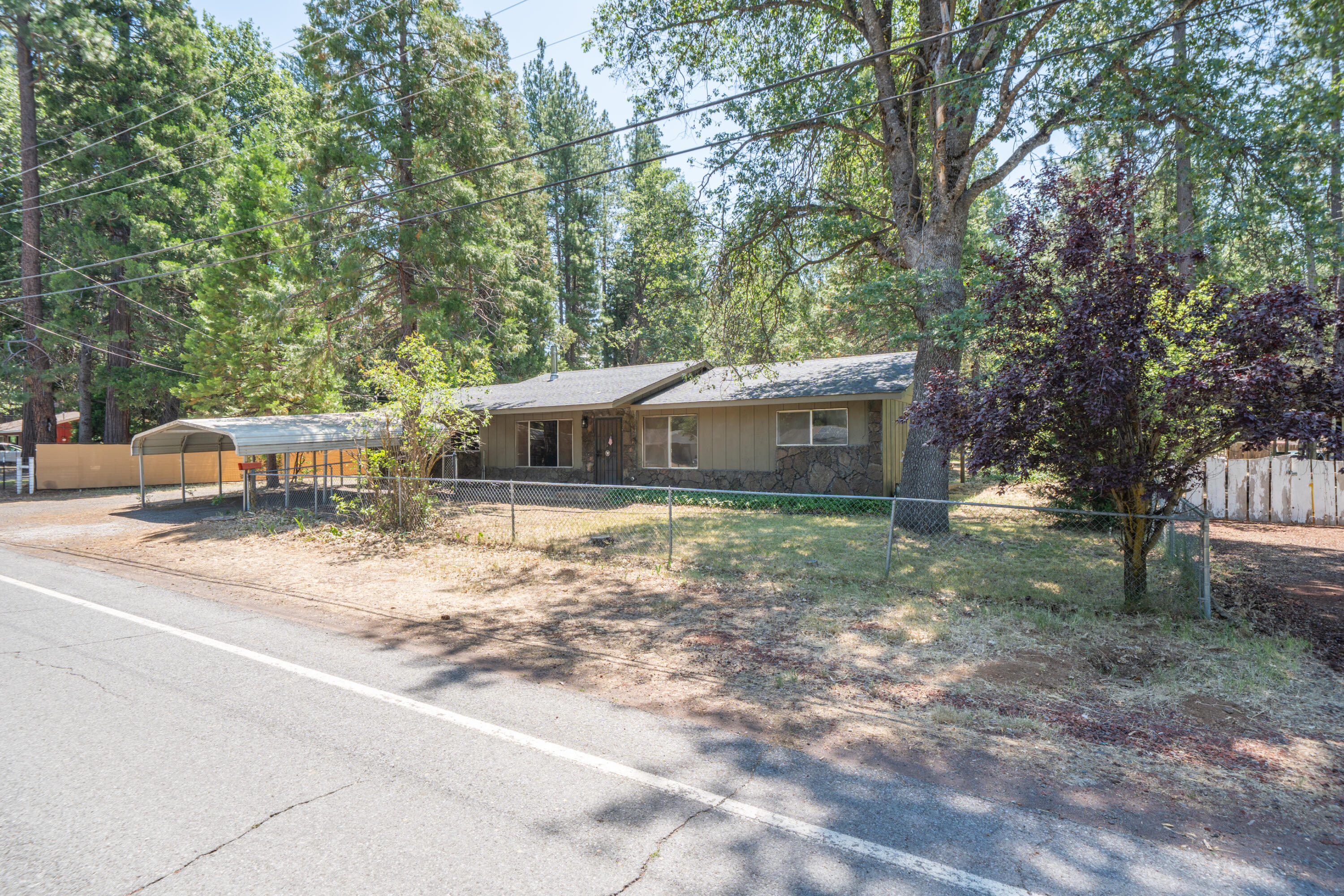 37347 Cypress Avenue Burney, CA 96013 - Photo 2 of 62 a front view of a house with a yard and trees