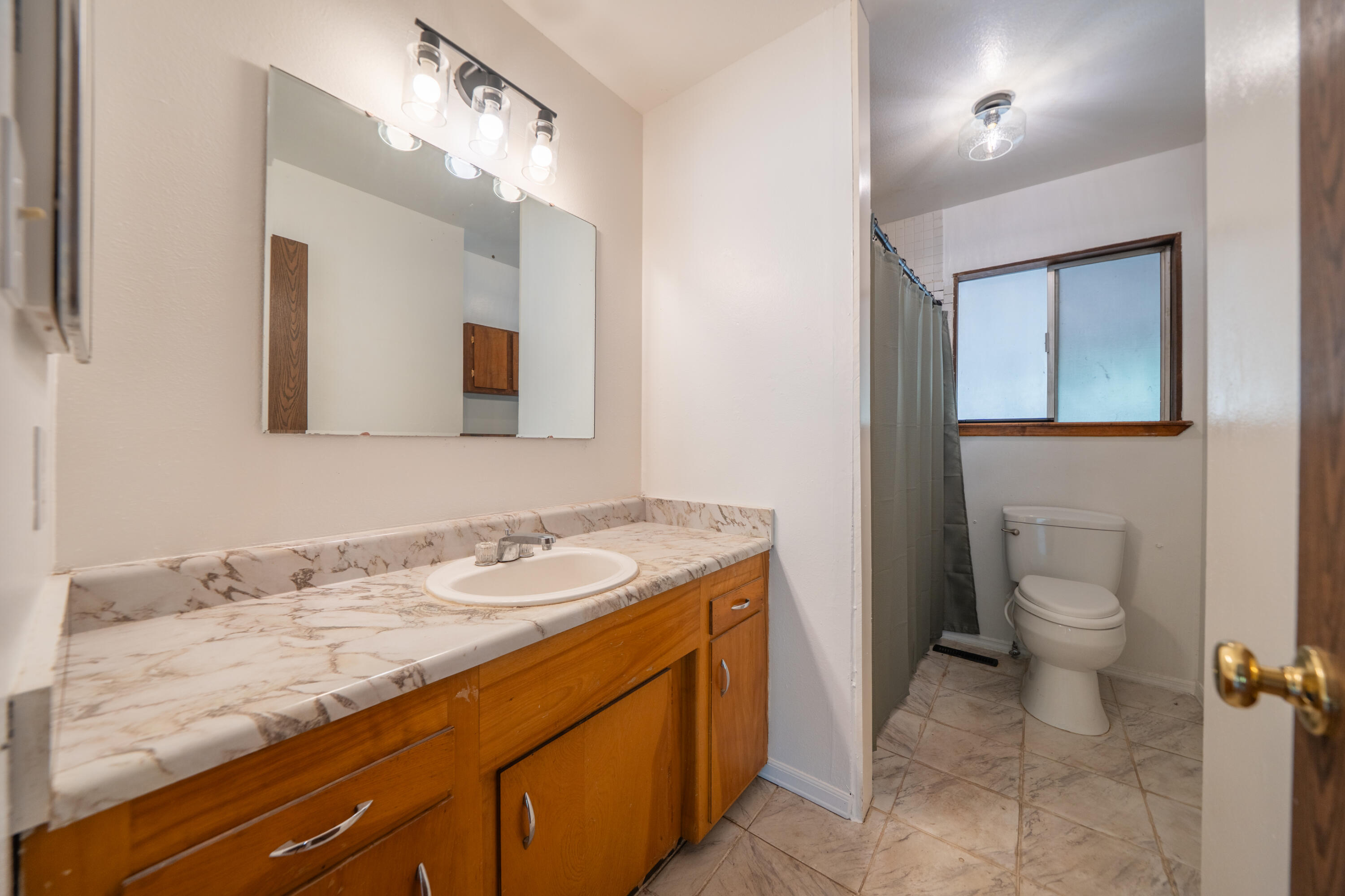 37347 Cypress Avenue Burney, CA 96013 - Photo 28 of 62 a bathroom with a granite countertop sink mirror and toilet