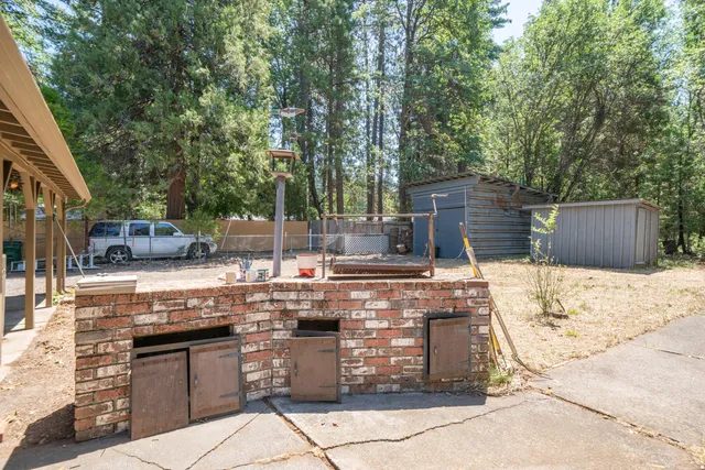 a side view of a house with a wooden fence