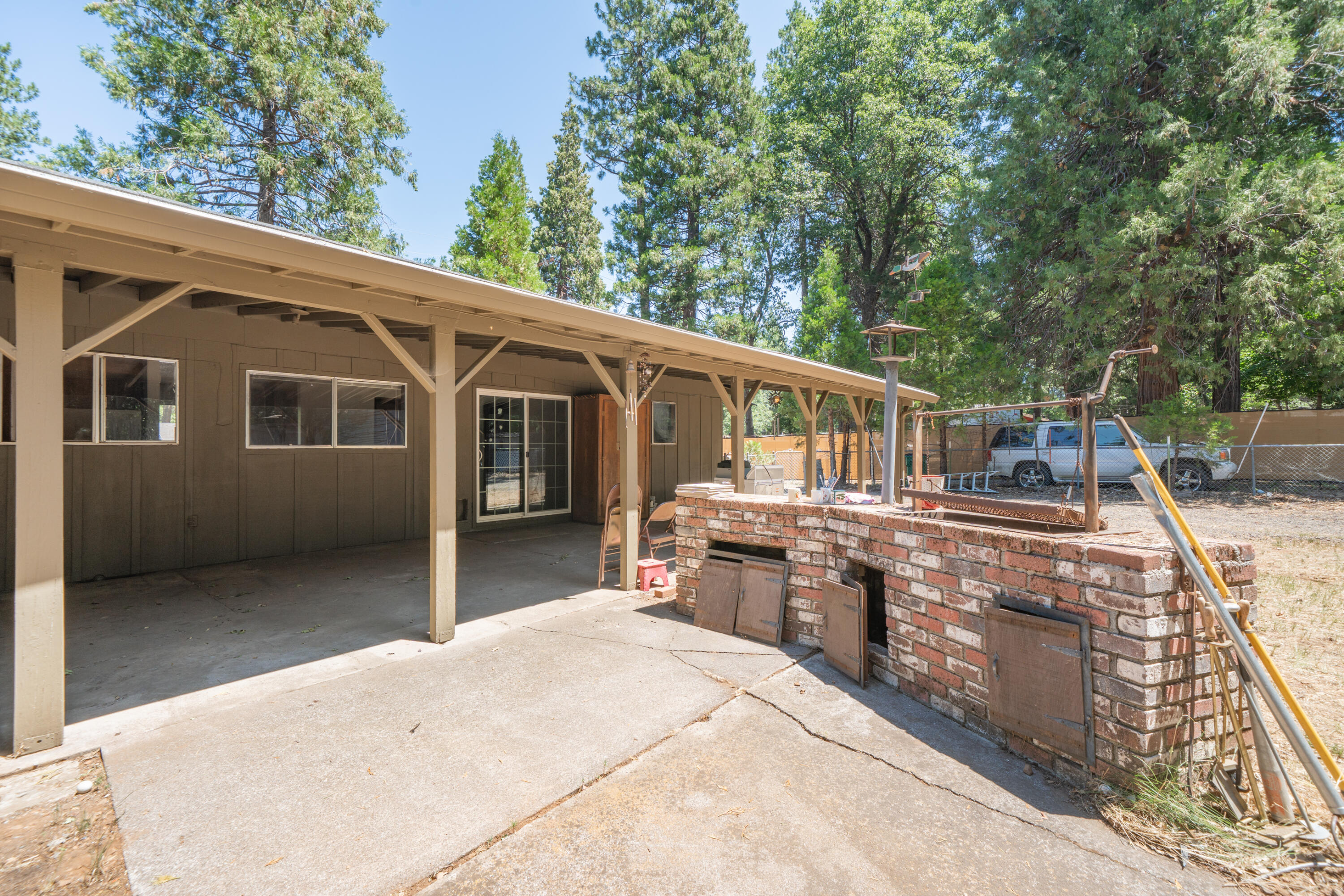 37347 Cypress Avenue Burney, CA 96013 - Photo 42 of 62 a front view of house with yard outdoor seating and barbeque oven
