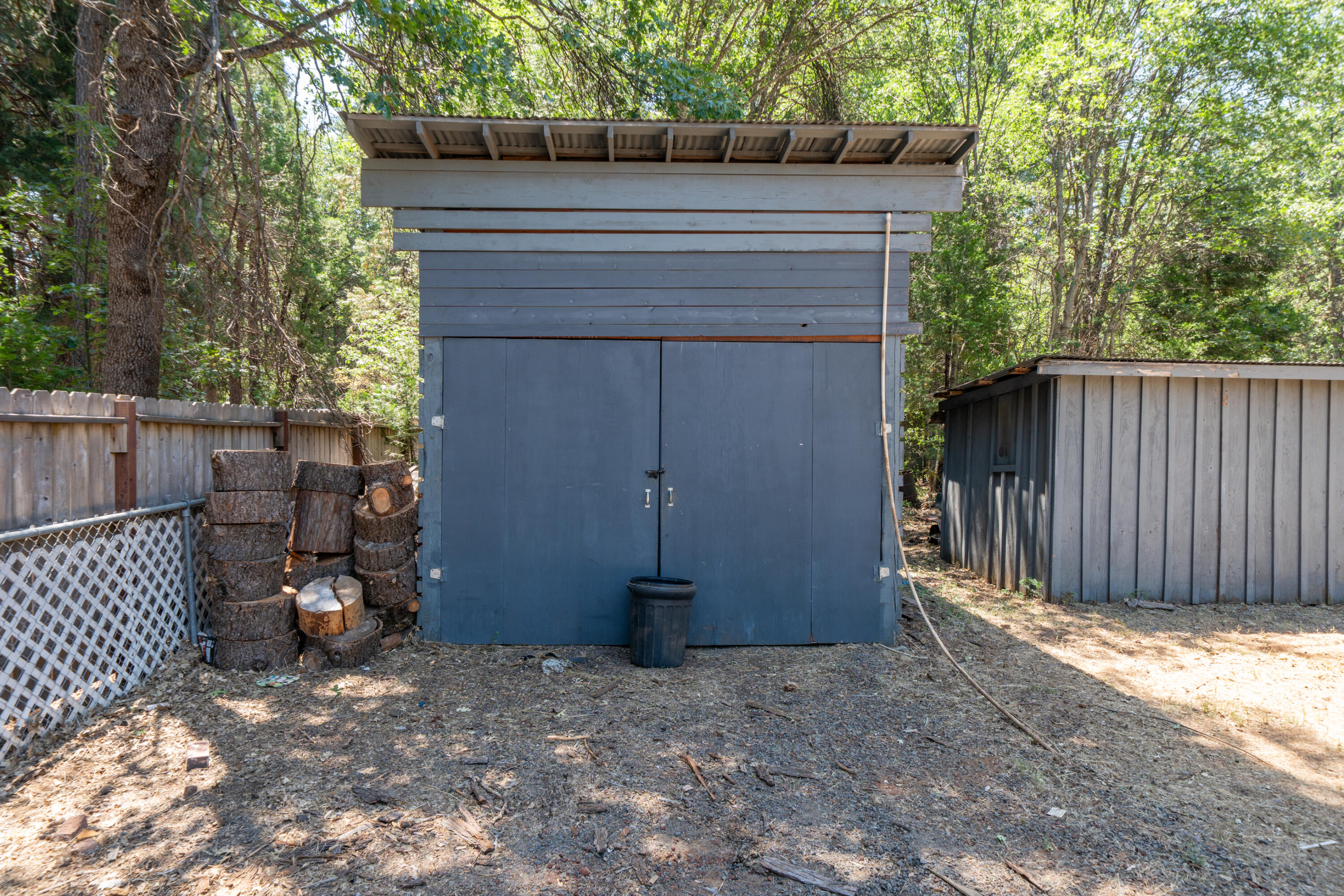 37347 Cypress Avenue Burney, CA 96013 - Photo 44 of 62 a side view of a house with a wooden fence