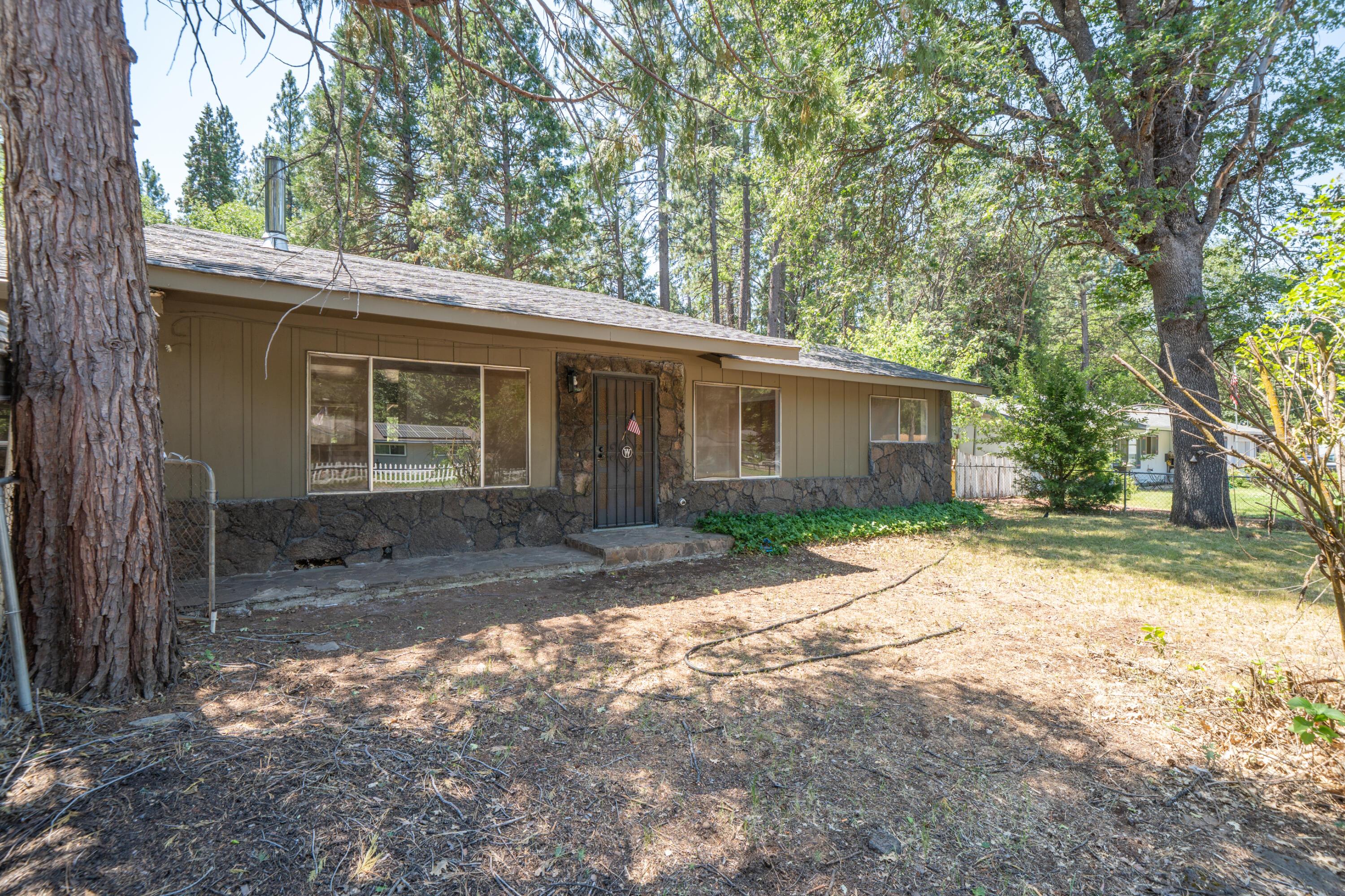 37347 Cypress Avenue Burney, CA 96013 - Photo 7 of 62 a view of a yard with a house and a large tree