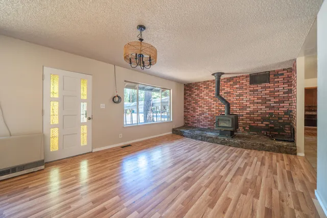 a view of a livingroom with furniture hardwood floor and a kitchen