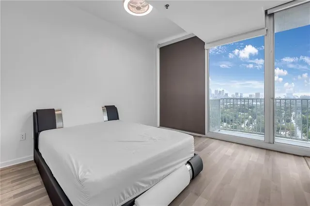 a bedroom with a bed and a night stand