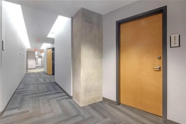 a view of a hallway with wooden floor