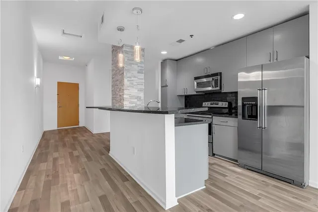 a kitchen with refrigerator and microwave