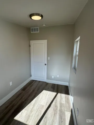 a view of a room with wooden floor