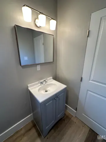 a bathroom with a sink mirror and vanity