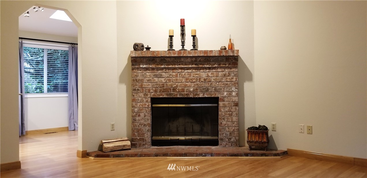 36308 25th Place South Federal Way, WA 98003 - Photo 13 of 27 a living room with a fireplace and wooden floor