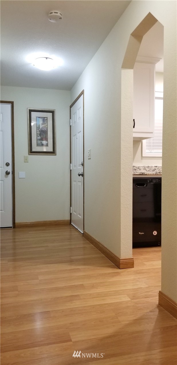 36308 25th Place South Federal Way, WA 98003 - Photo 22 of 27 a view of empty room with kitchen natural light and wooden floor