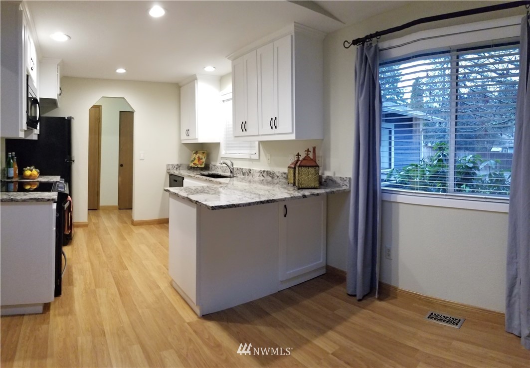 36308 25th Place South Federal Way, WA 98003 - Photo 5 of 27 a kitchen with a sink appliances cabinets and a large window