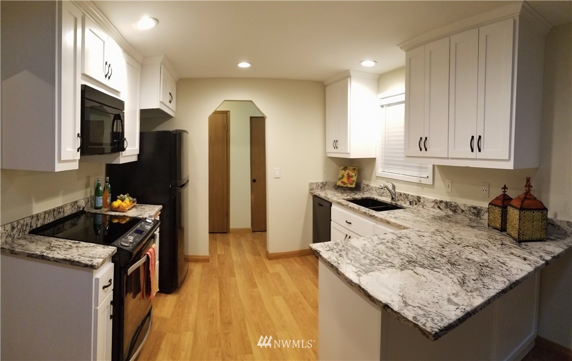 36308 25th Place South Federal Way, WA 98003 - Photo 6 of 27 a kitchen with stainless steel appliances granite countertop a sink stove and refrigerator