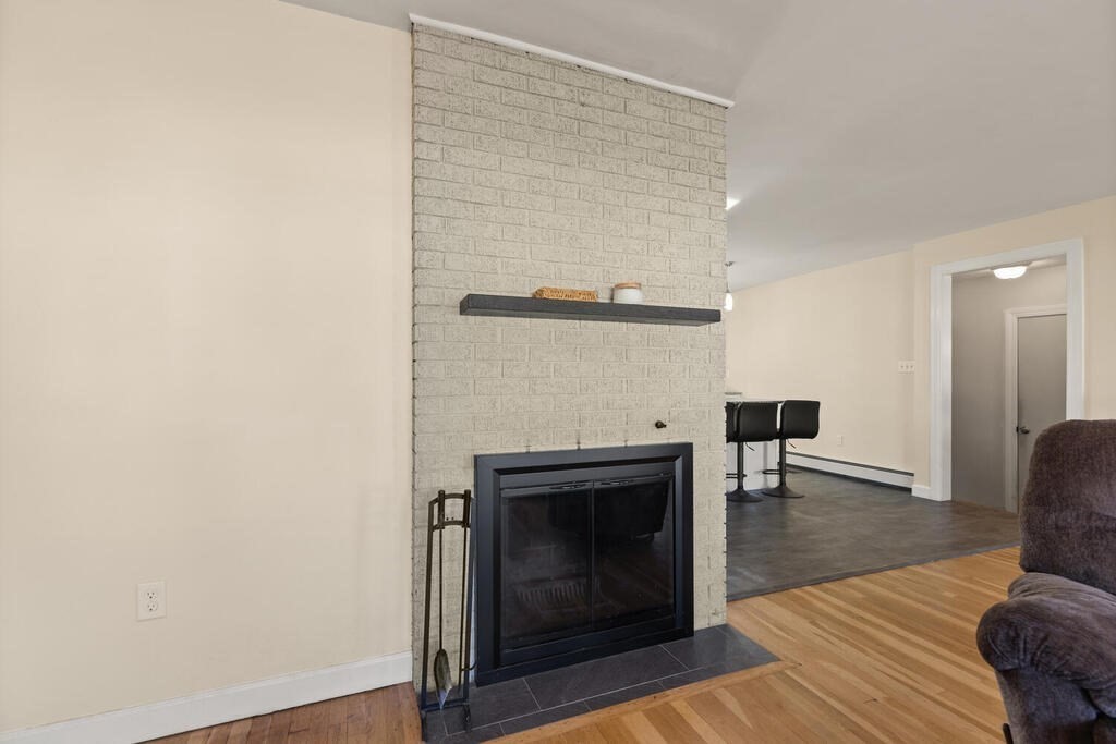 122 Gilman Street Nashua, NH 03060 - Photo 11 of 31 a living room with furniture and a fireplace