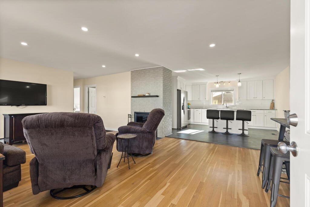 122 Gilman Street Nashua, NH 03060 - Photo 13 of 31 a living room with furniture and a flat screen tv