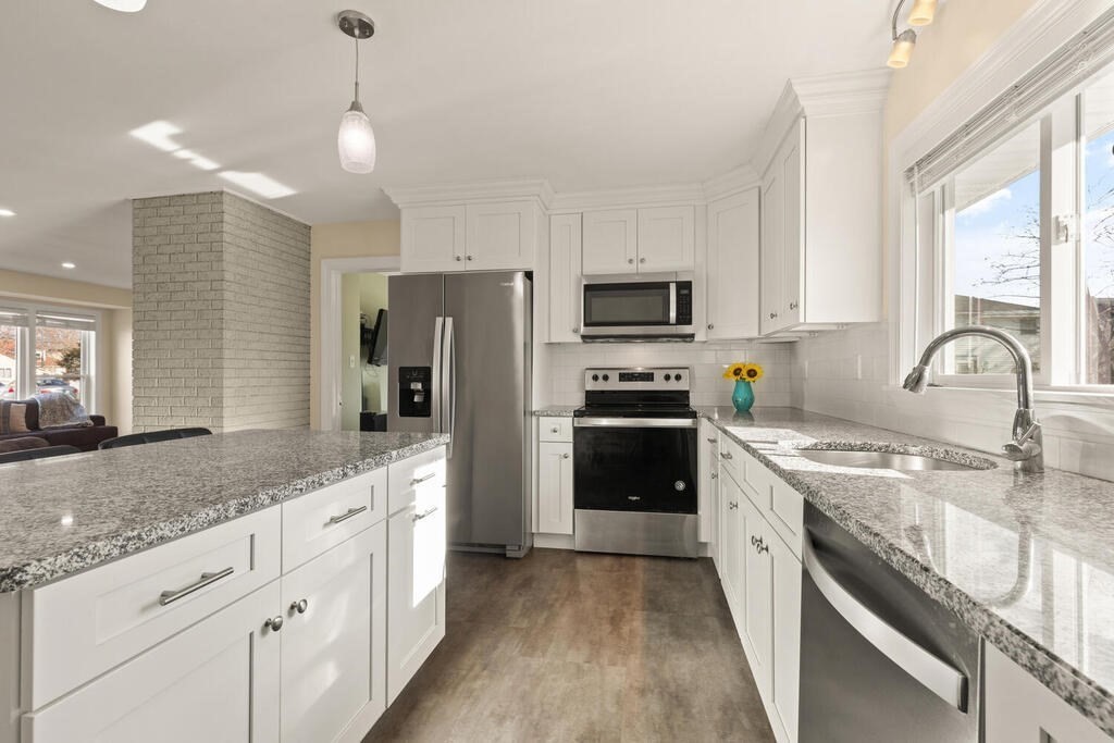122 Gilman Street Nashua, NH 03060 - Photo 19 of 31 a kitchen with a sink stove and refrigerator