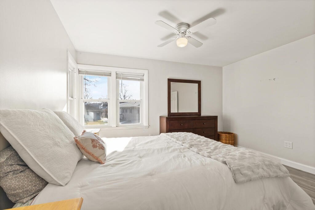 122 Gilman Street Nashua, NH 03060 - Photo 22 of 31 a bedroom with a large bed and a chandelier