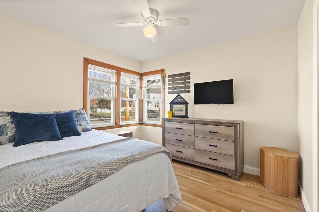 122 Gilman Street Nashua, NH 03060 - Photo 24 of 31 a bedroom with a bed and a flat screen tv