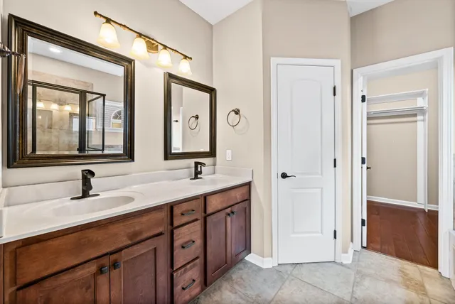 a bathroom with a double vanity sink and mirror